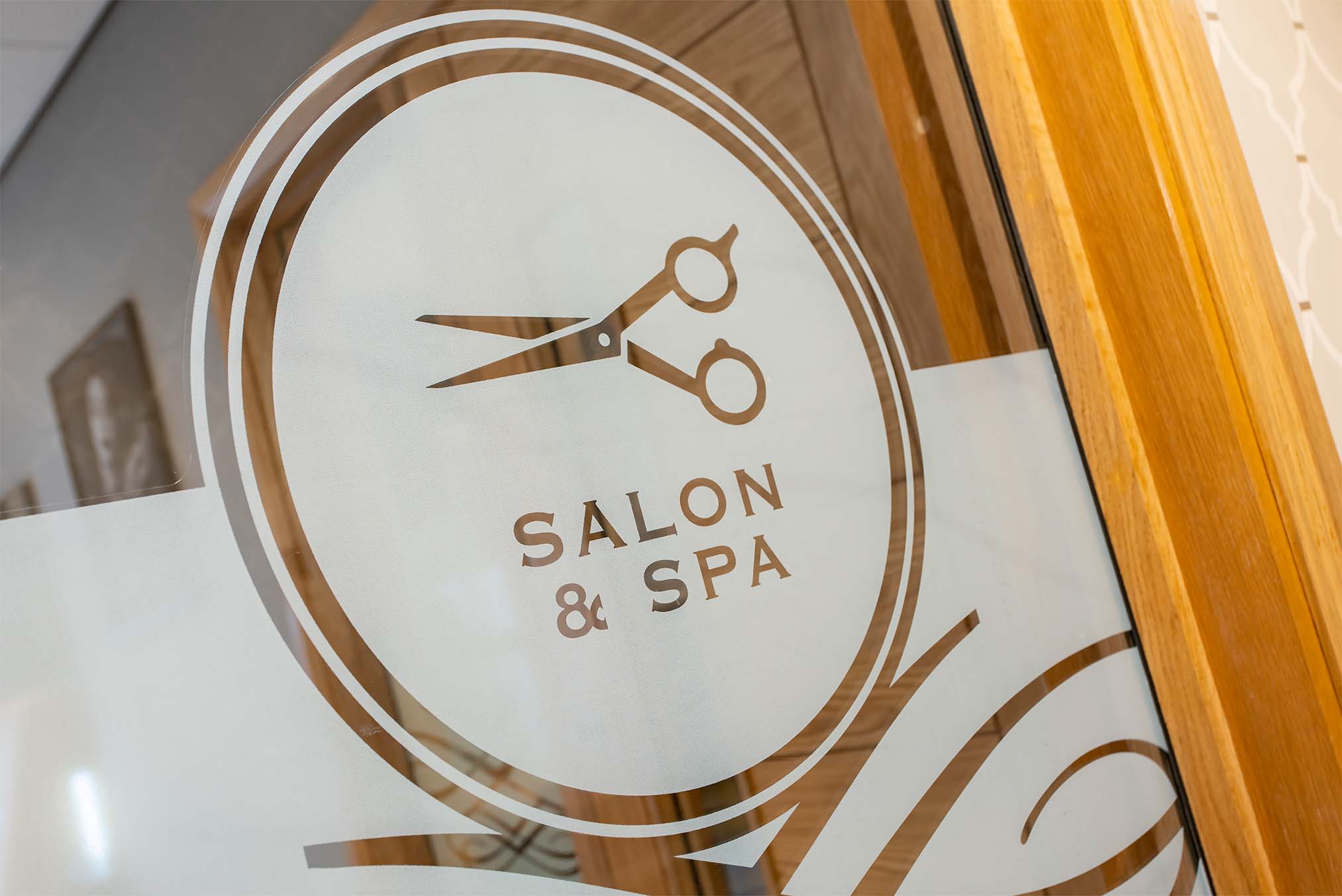 sign on glass door for Salon & Spa