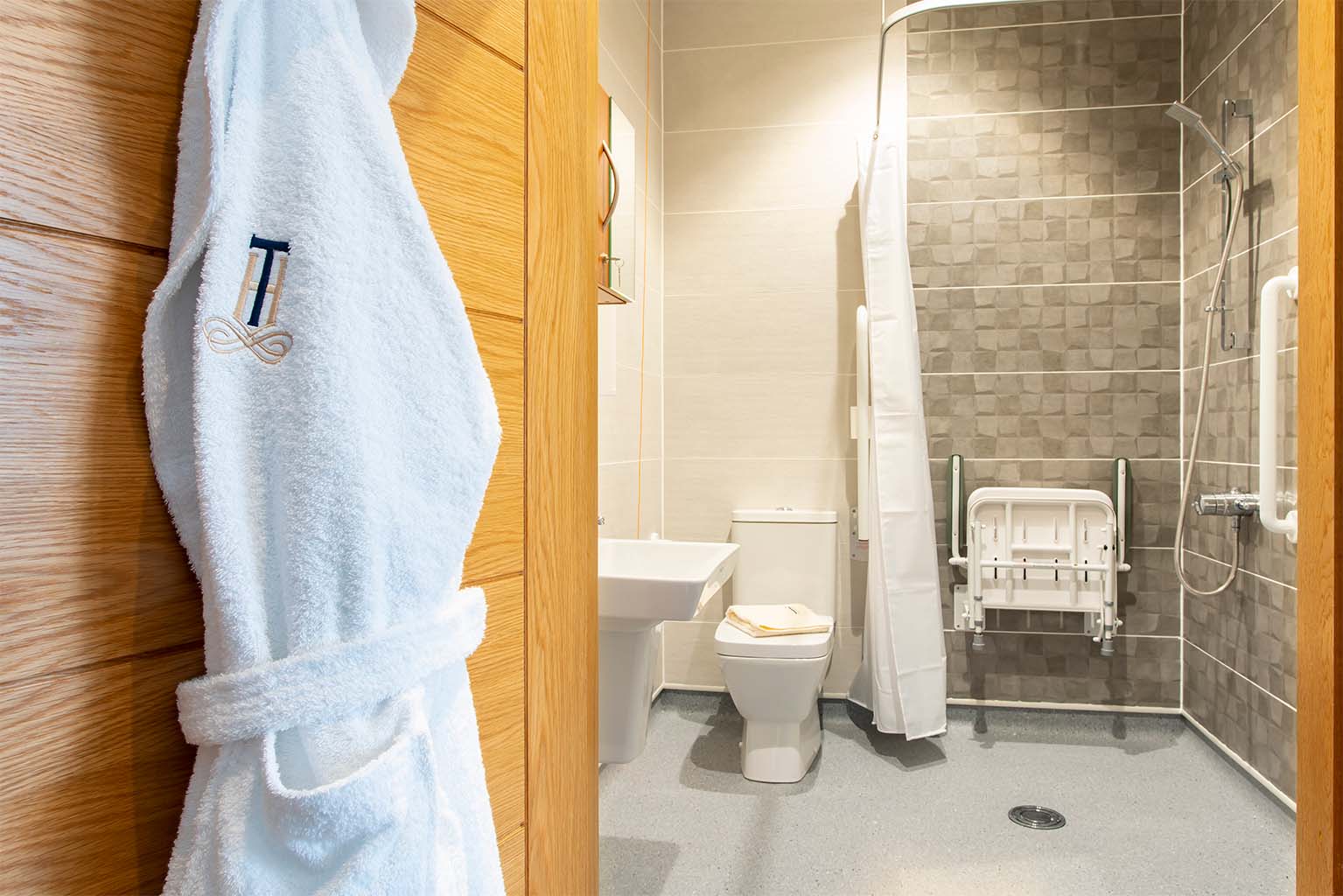 en suite bathroom in a care home with branded dressing gown