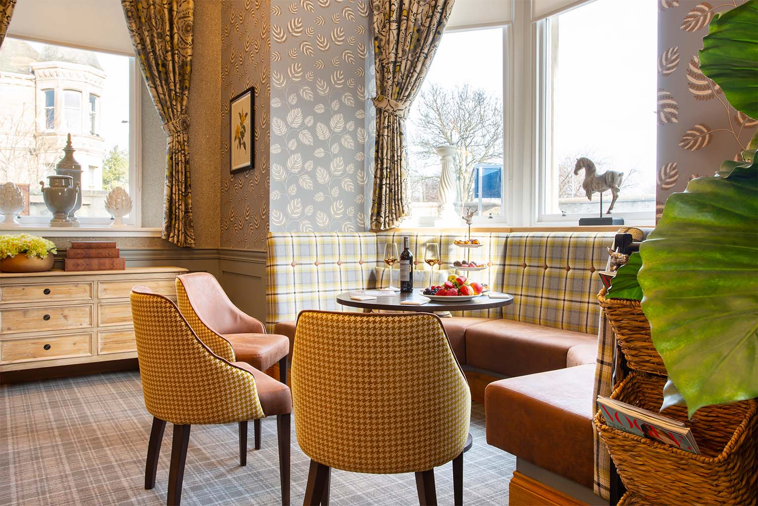 comfortable chairs around a table near bay window