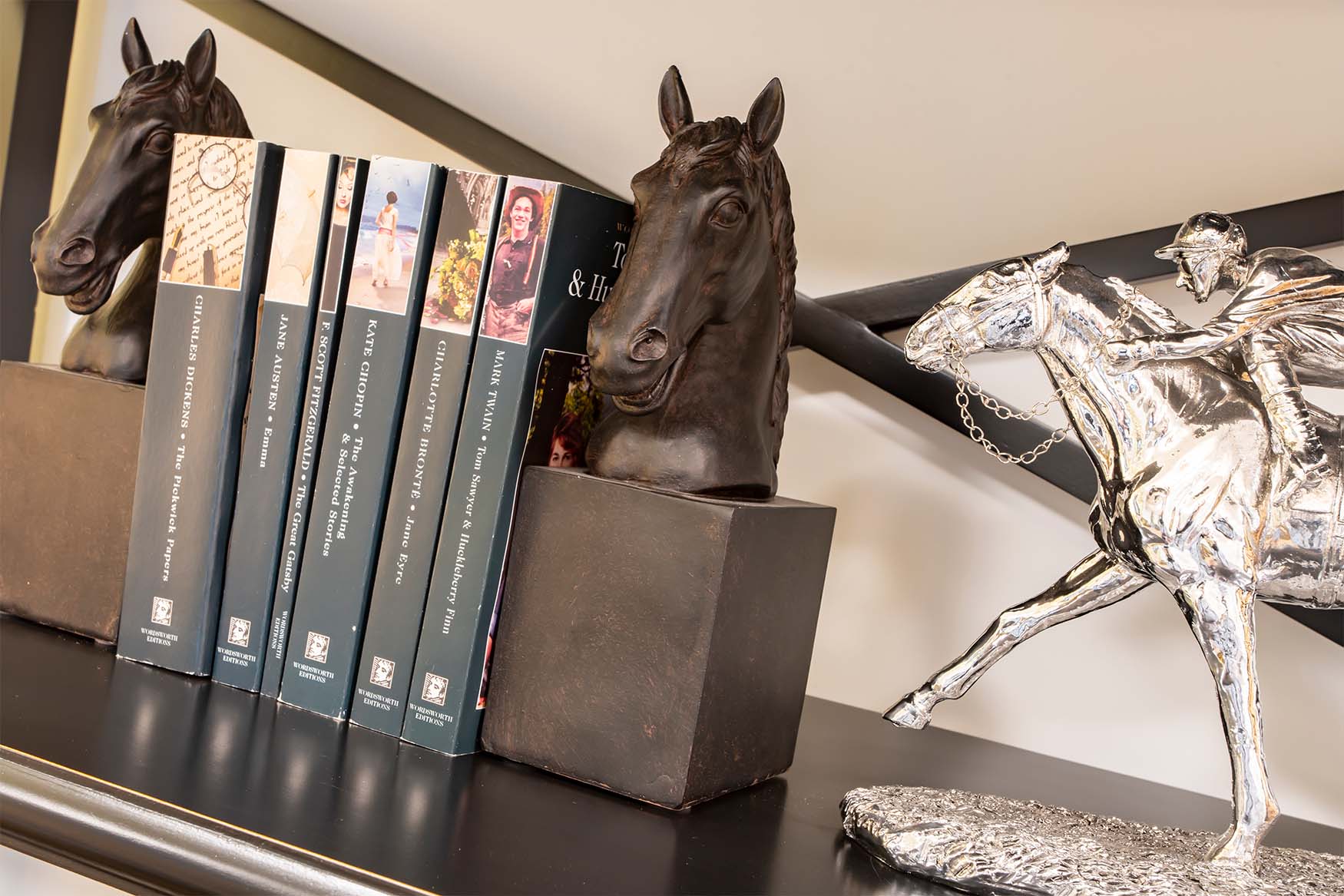 bookshelf with horse shaped bookends