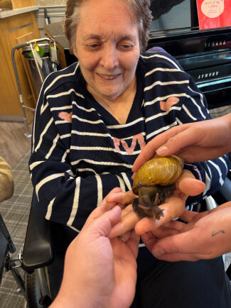 Celebrating World Animal Day at Trinity House with Zoo Lab's animals, and how interaction with animals benefits our residents.