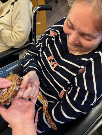 Celebrating World Animal Day at Trinity House with Zoo Lab's animals, and how interaction with animals benefits our residents.