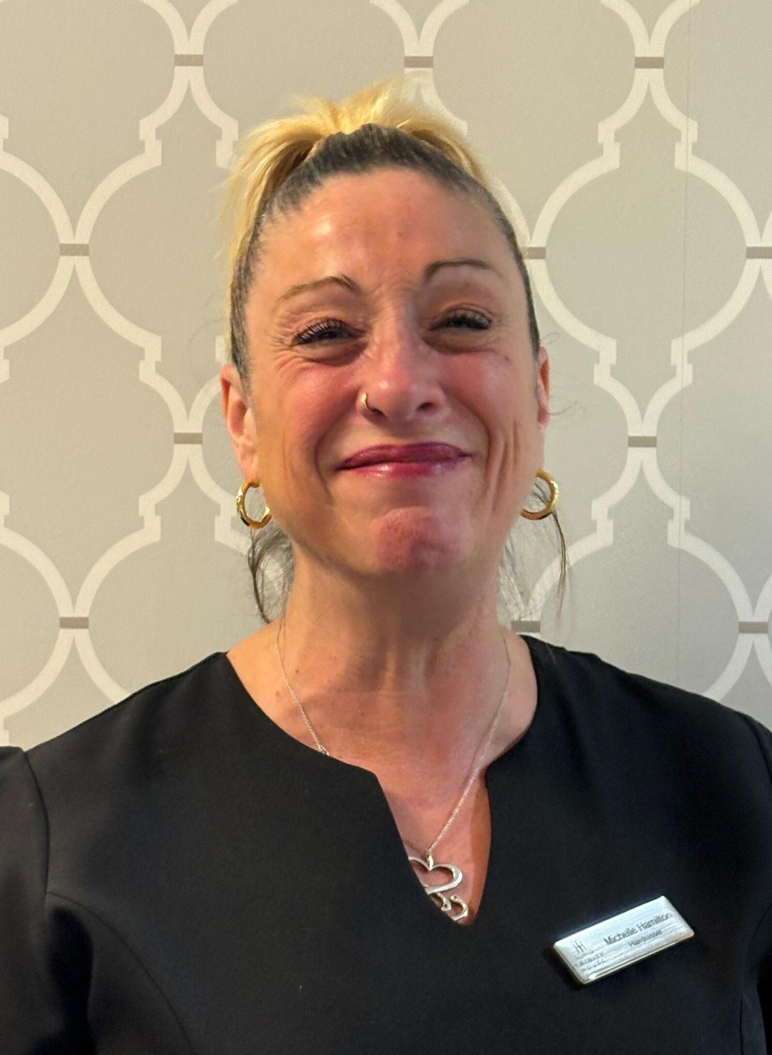 woman with blonde ponytail smiling