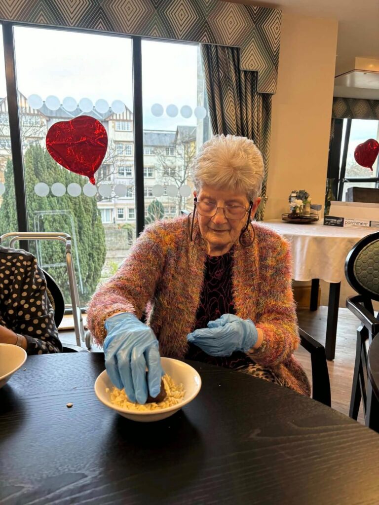 care home resident baking cookies
