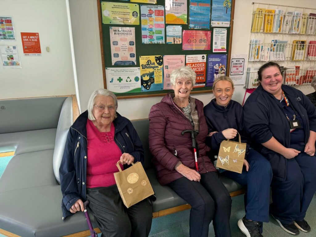 care home residents smile in GP waiting room to give gifts to local doctors and nurses