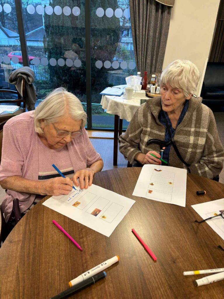 elderly women writing kind notes to community