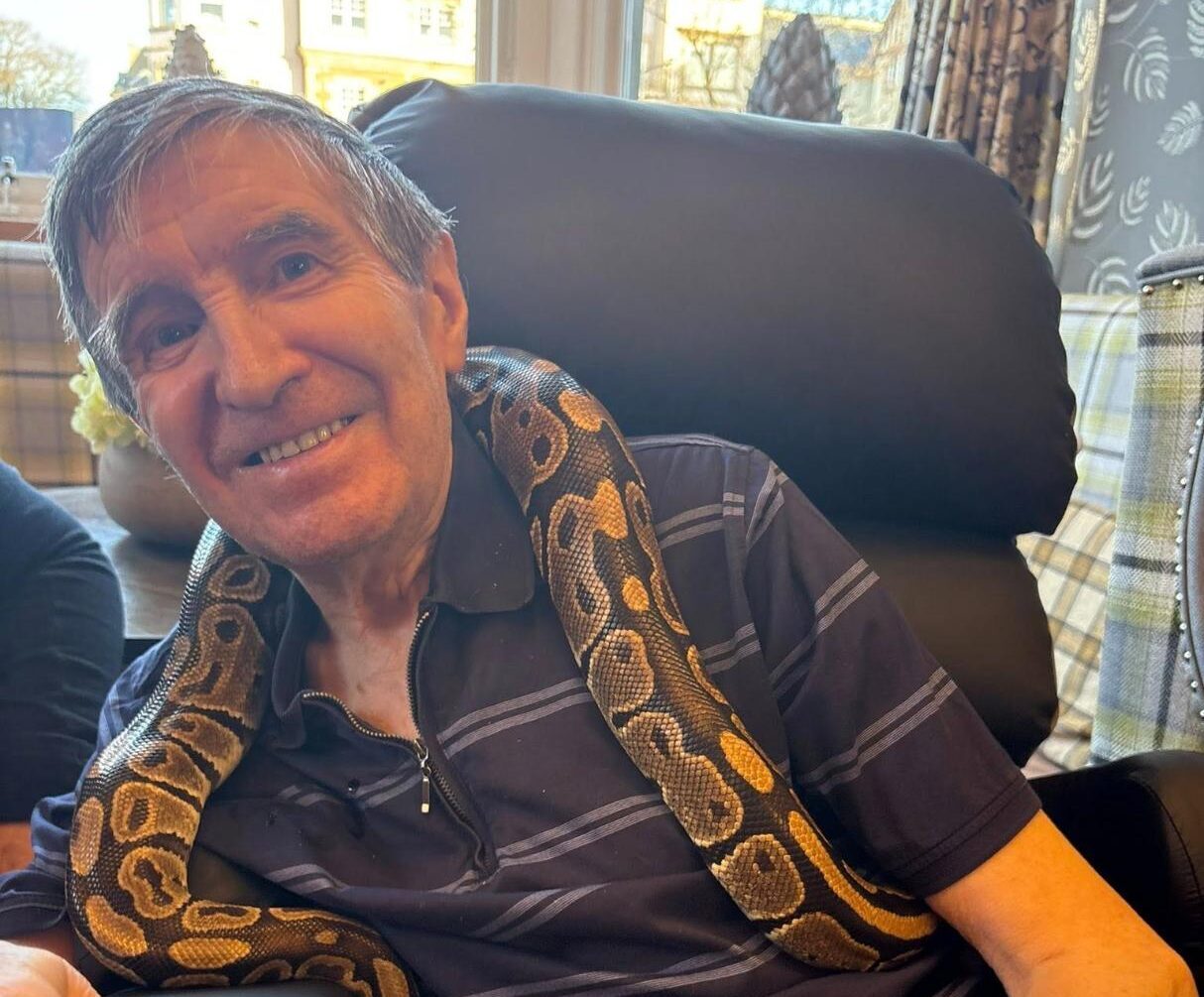 resident holding a snake